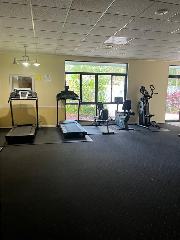 3300 Fox Chase Circle, Unit 226 Palm Harbor, FL 34683 - Photo 11 of 13 a lobby with furniture and floor to ceiling window