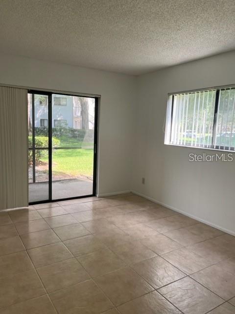 3300 Fox Chase Circle, Unit 226 Palm Harbor, FL 34683 - Photo 5 of 13 an empty room with windows