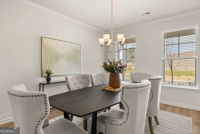 a view of a dining room with furniture and chandelier