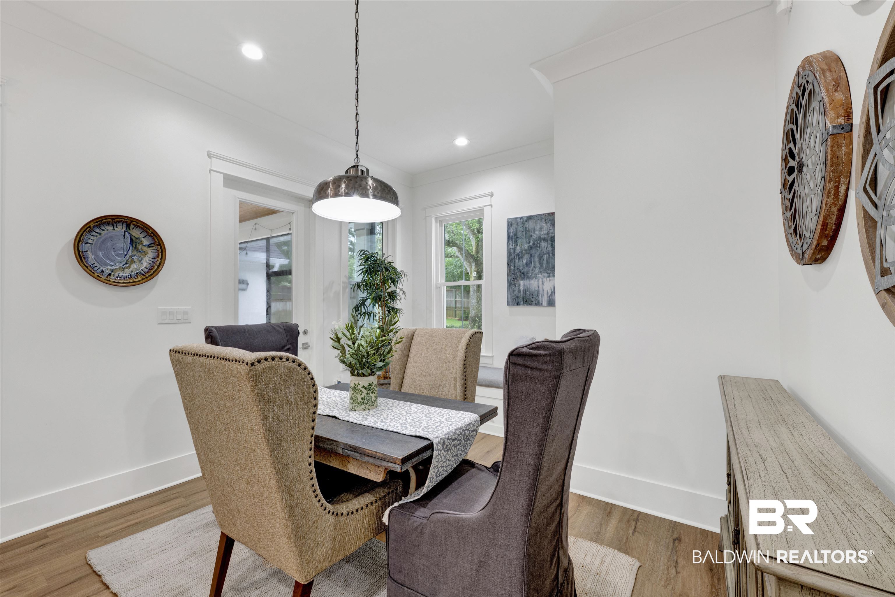 21702 Pillars Street Fairhope, AL 36532 - Photo 15 of 54 Dining area featuring wood-finish flooring, white trim, recessed lighting, and a prominent industrial-style pendant light