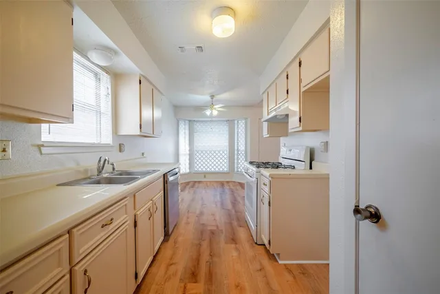 a kitchen with a sink stove and cabinets