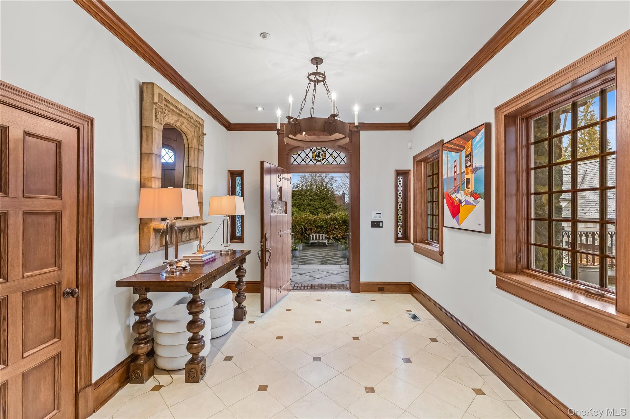 19 Park Drive South Rye, NY 10580 - Photo 7 of 42 Foyer featuring suspended lighting, marble floors, and detailed molding.