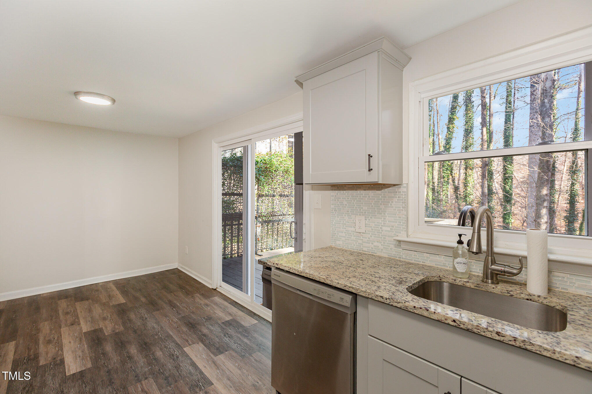 7324 Summerland Drive Raleigh, NC 27612 - Photo 10 of 24 a kitchen with granite countertop a sink and a window