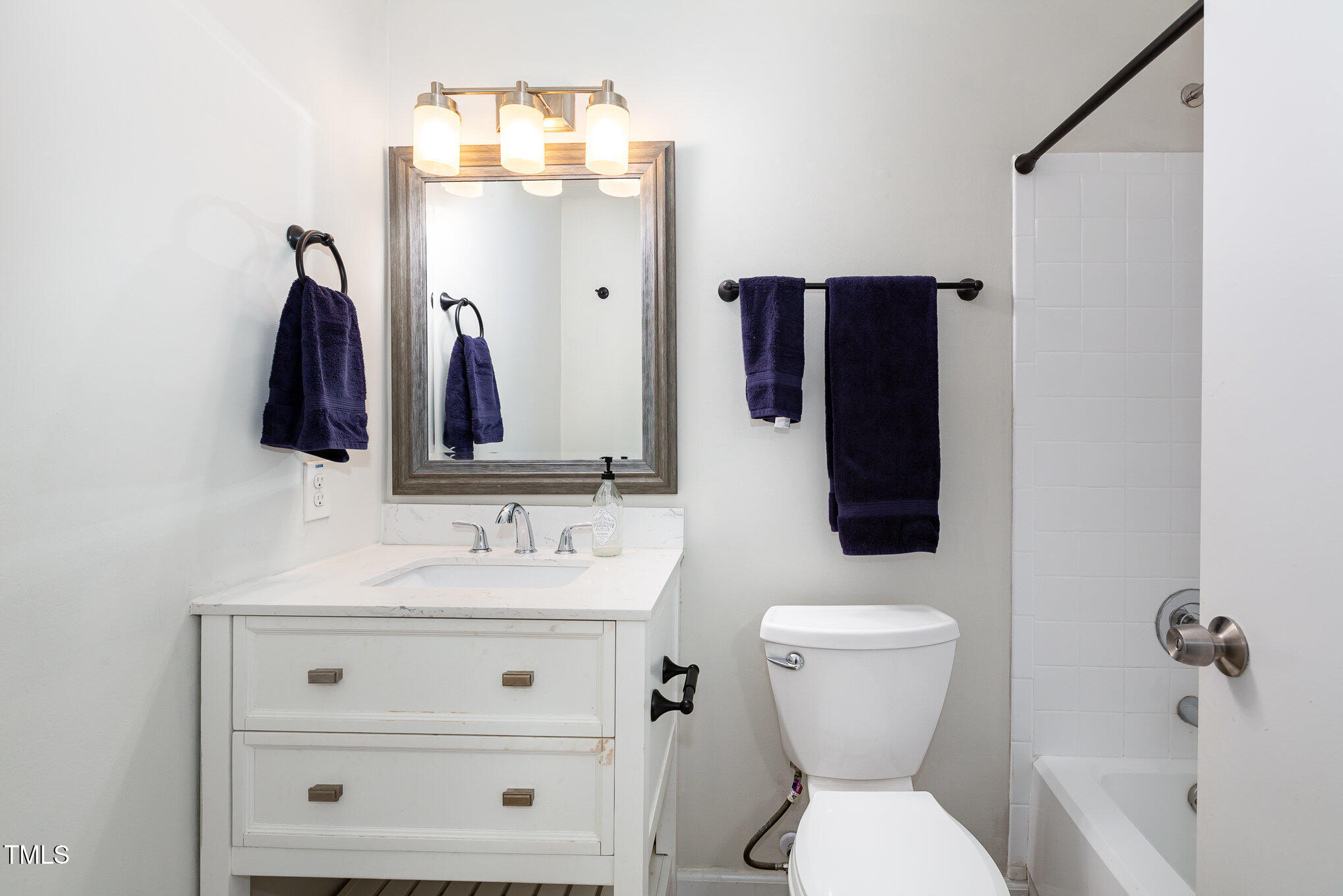 7324 Summerland Drive Raleigh, NC 27612 - Photo 12 of 24 a bathroom with a sink vanity mirror and toilet