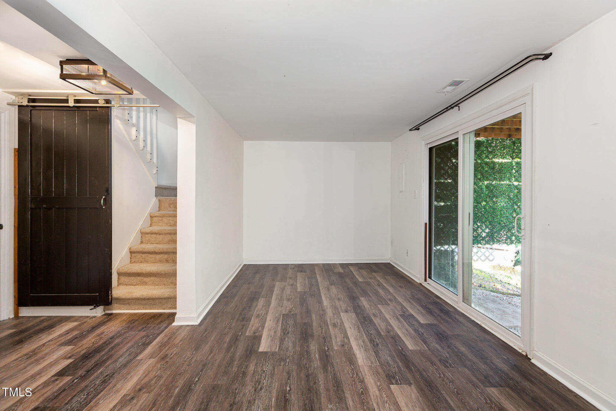 7324 Summerland Drive Raleigh, NC 27612 - Photo 17 of 24 a view of empty room with wooden floor and fan