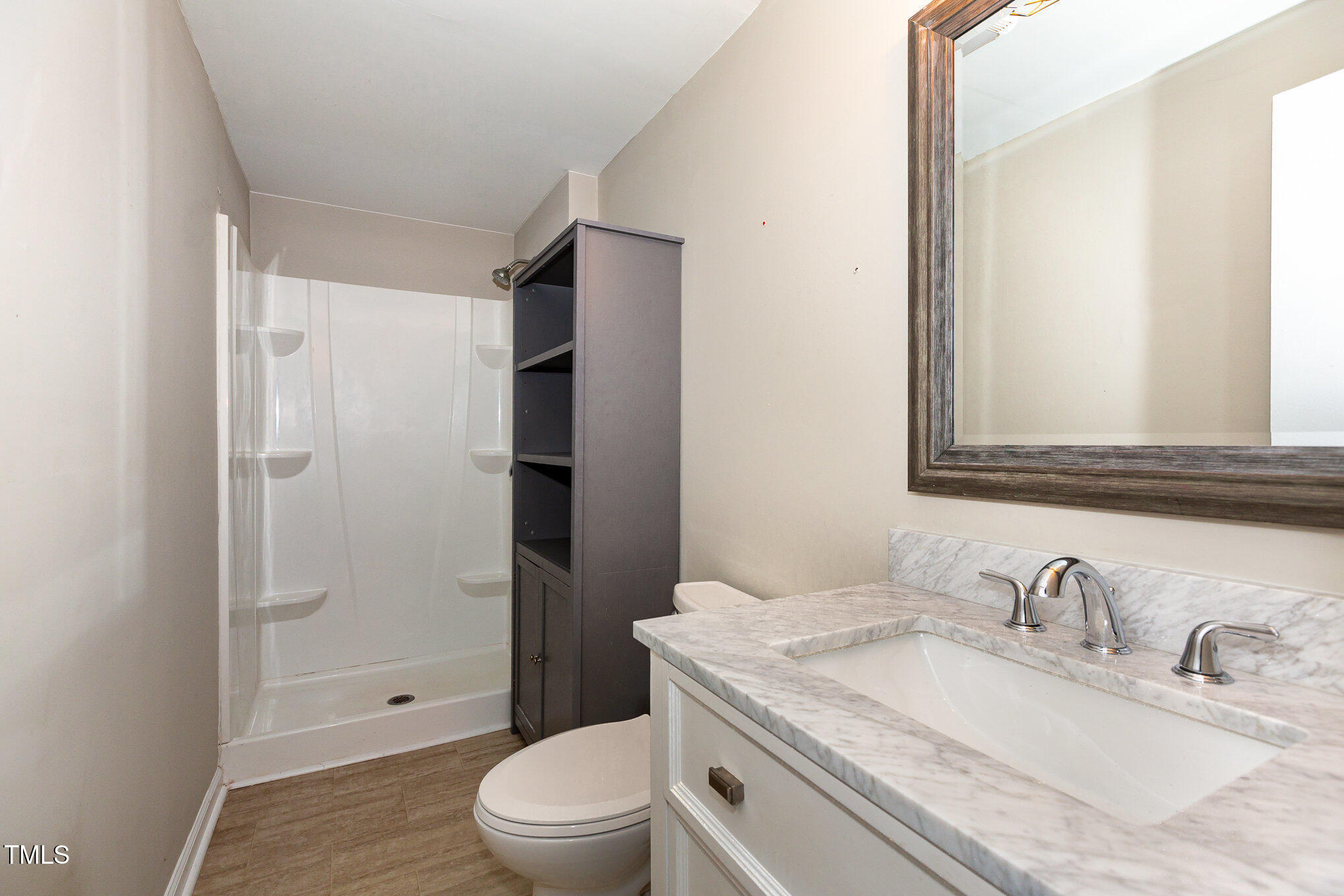 7324 Summerland Drive Raleigh, NC 27612 - Photo 19 of 24 a bathroom with a granite countertop sink toilet and shower