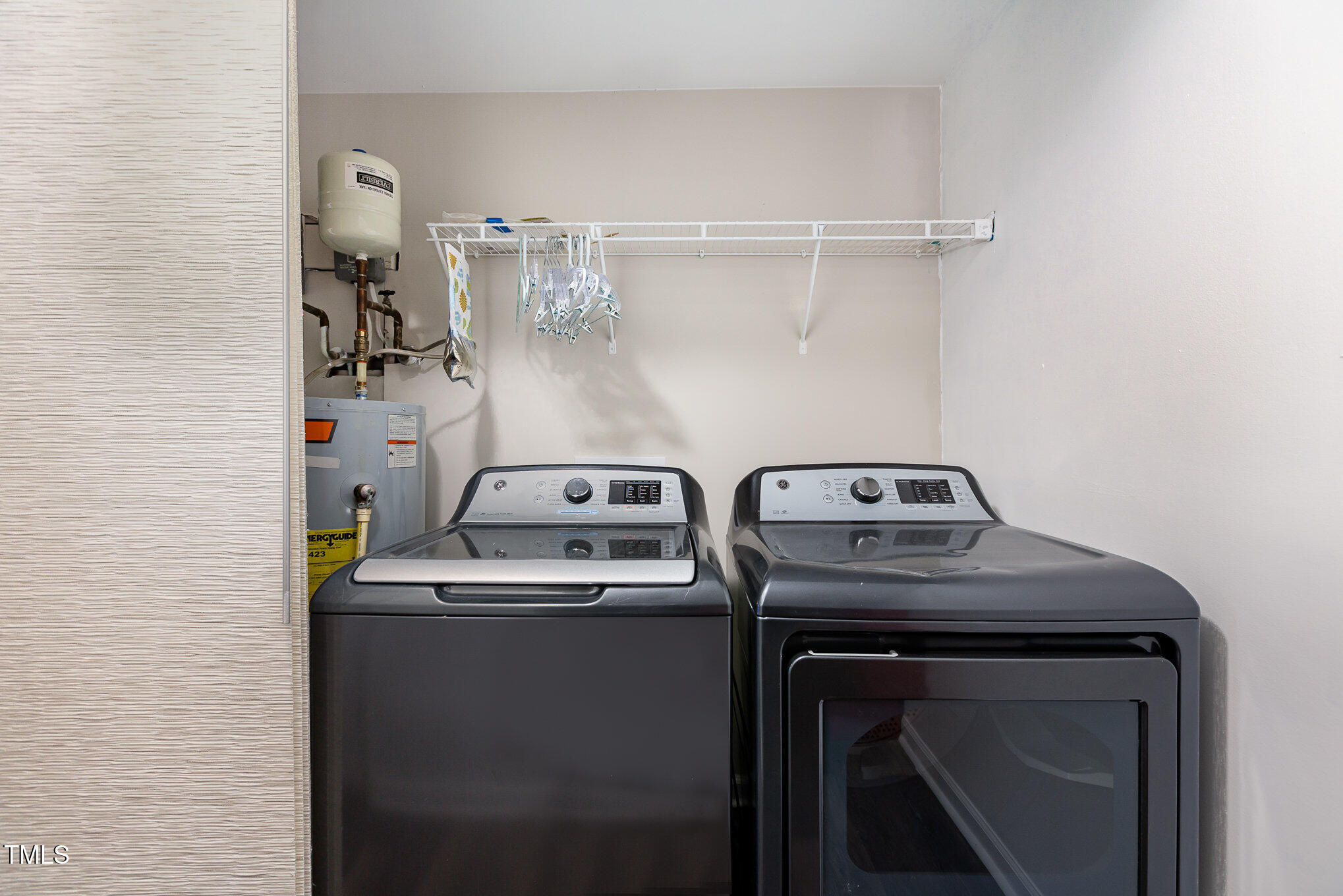 7324 Summerland Drive Raleigh, NC 27612 - Photo 20 of 24 a view of storage and utility room with washer and dryer