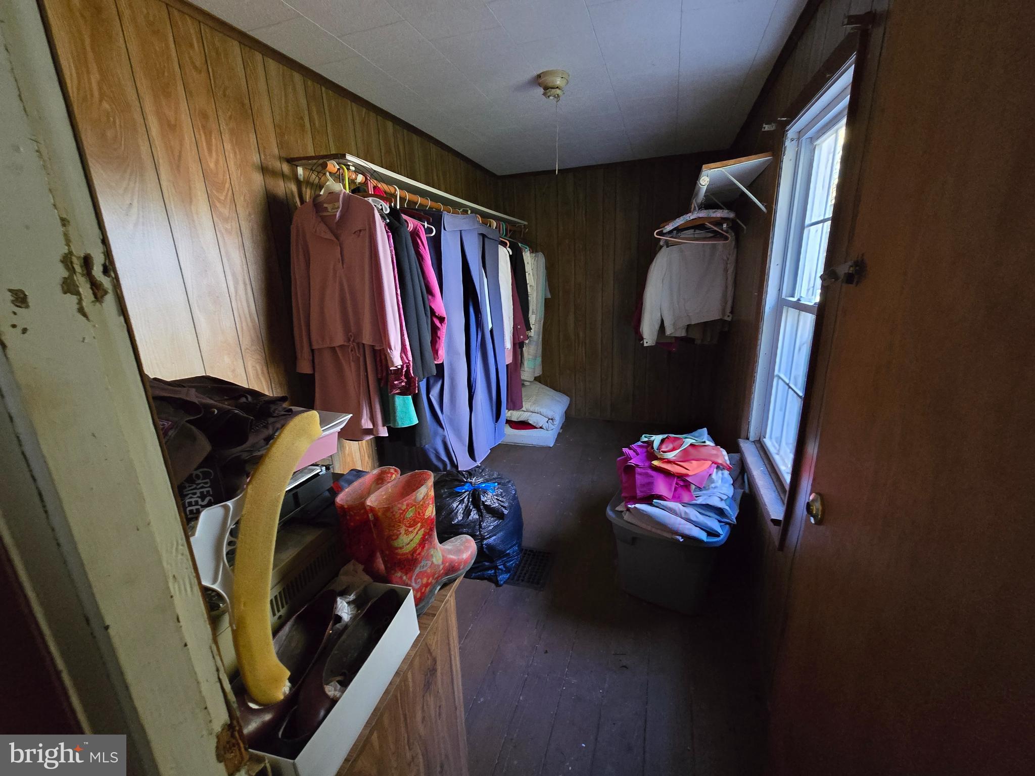 26934 Old State Road Crisfield, MD 21817 - Photo 5 of 15 a bedroom with a bed and a mirror