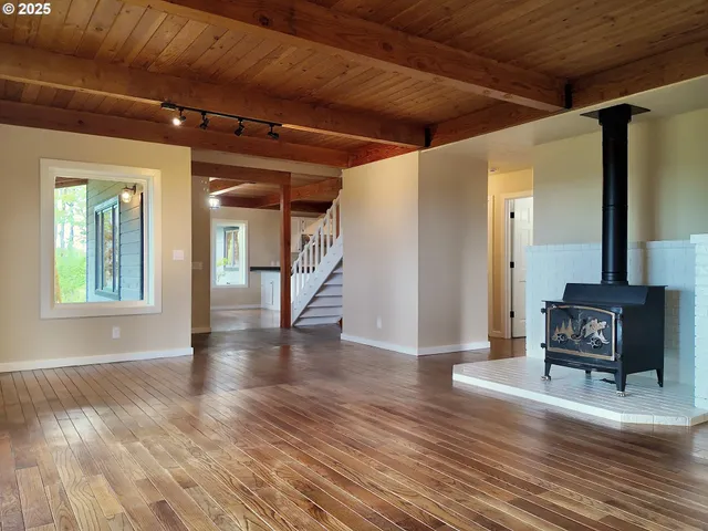 a view of a hallway with wooden floor and a fireplace