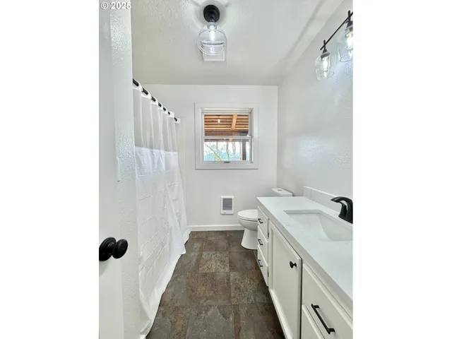 a bathroom with a double vanity sink a mirror and a bathtub
