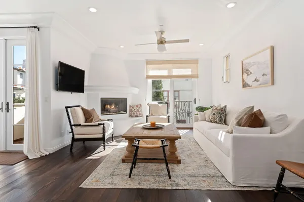 a living room with furniture a fireplace and a flat screen tv