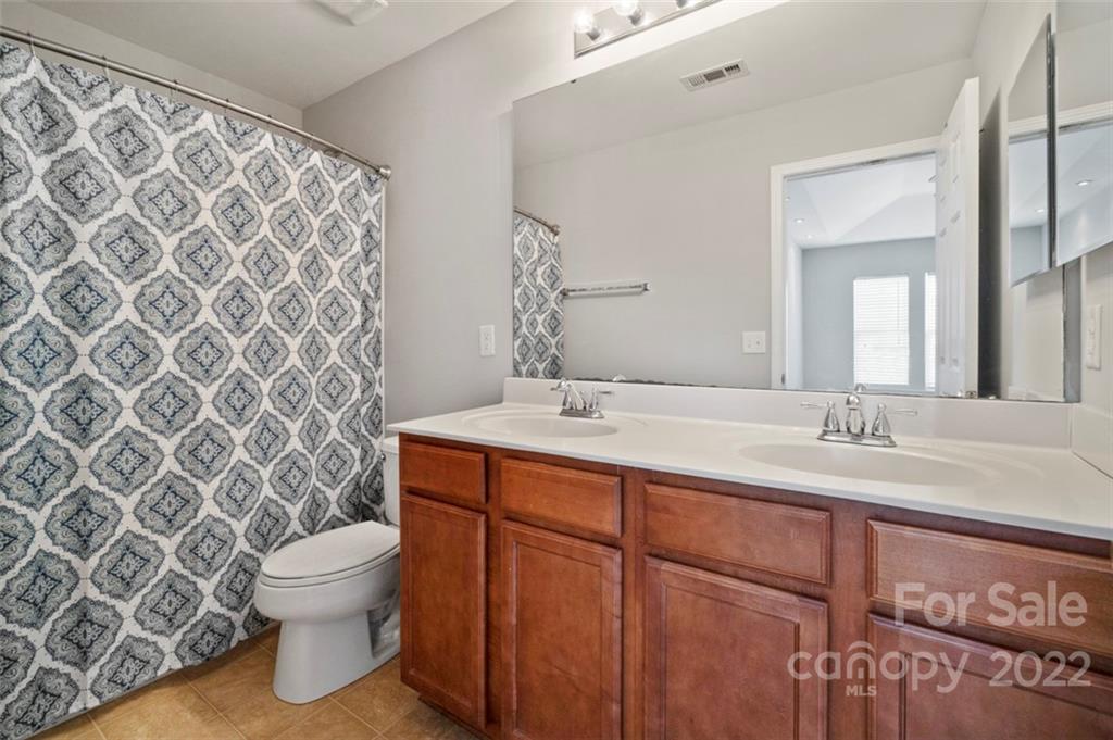 4416 Marys Point Road Monroe, NC 28110 - Photo 31 of 33 a bathroom with a granite countertop toilet sink and mirror