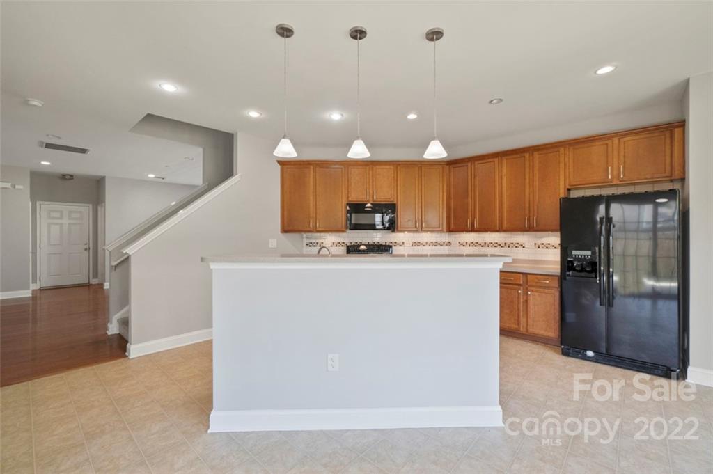 4416 Marys Point Road Monroe, NC 28110 - Photo 7 of 33 a kitchen with stainless steel appliances granite countertop a refrigerator a sink a stove and a refrigerator