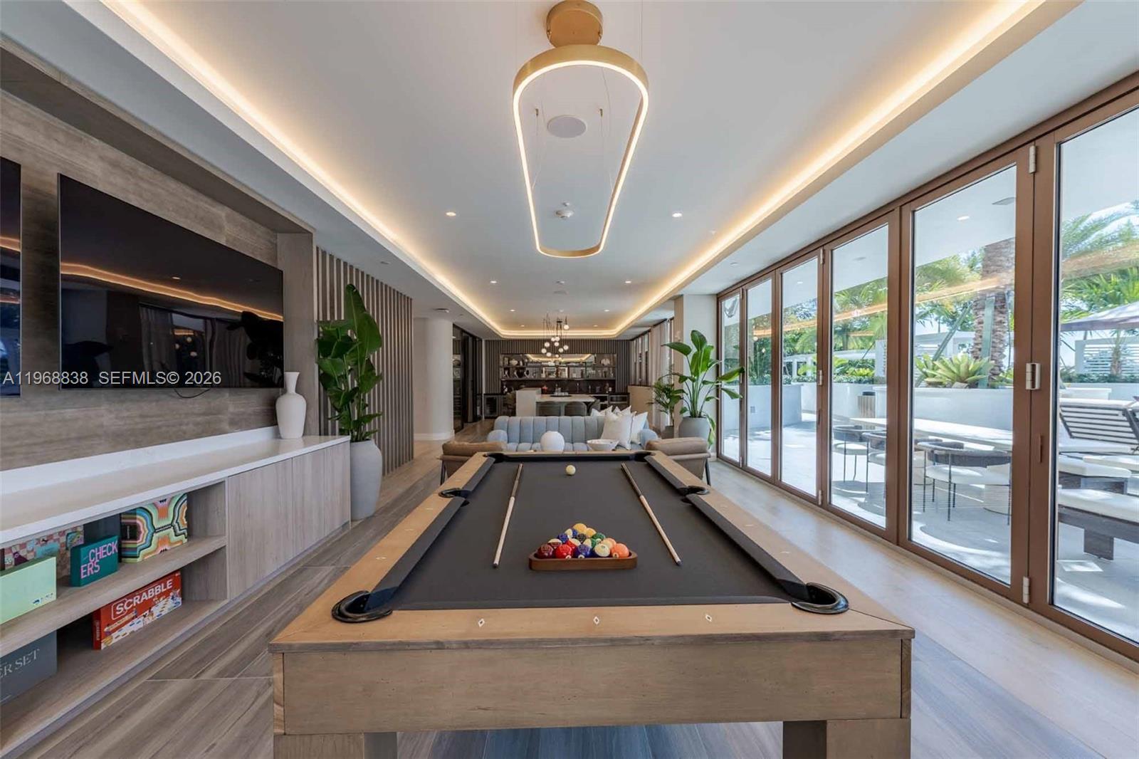 3900 Alton Road, Unit 318 Miami Beach, FL 33140 - Photo 16 of 42 a room with pool table and windows