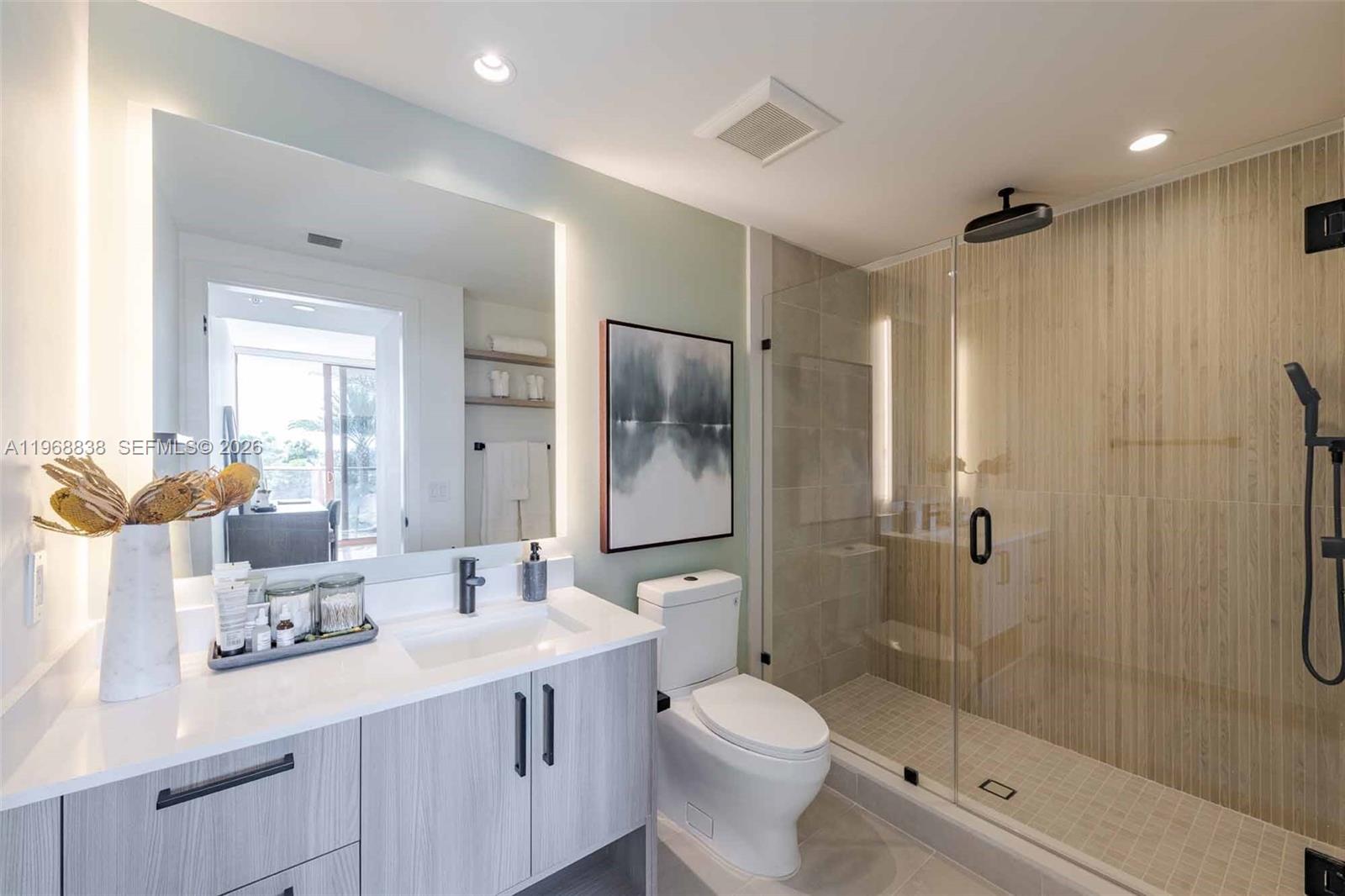 3900 Alton Road, Unit 318 Miami Beach, FL 33140 - Photo 42 of 42 a bathroom with a double vanity sink toilet and shower