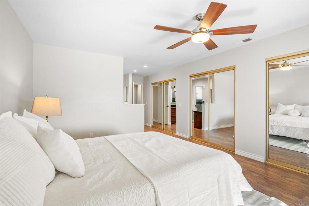 485 Wax Flower Lane Fallbrook, CA 92028 - Photo 12 of 31 a bedroom with a bed and a large mirror