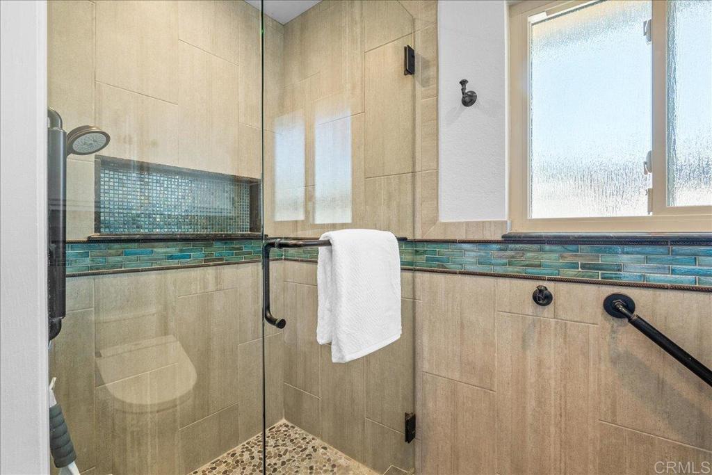 485 Wax Flower Lane Fallbrook, CA 92028 - Photo 16 of 31 a bathroom with a granite countertop shower and mirror