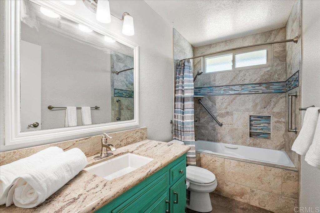 485 Wax Flower Lane Fallbrook, CA 92028 - Photo 17 of 31 a bathroom with a granite countertop sink a toilet a mirror and shower