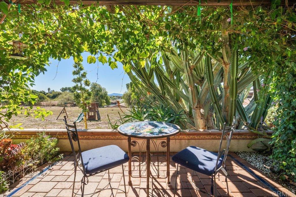 485 Wax Flower Lane Fallbrook, CA 92028 - Photo 20 of 31 a view of patio with table and chairs and potted plants