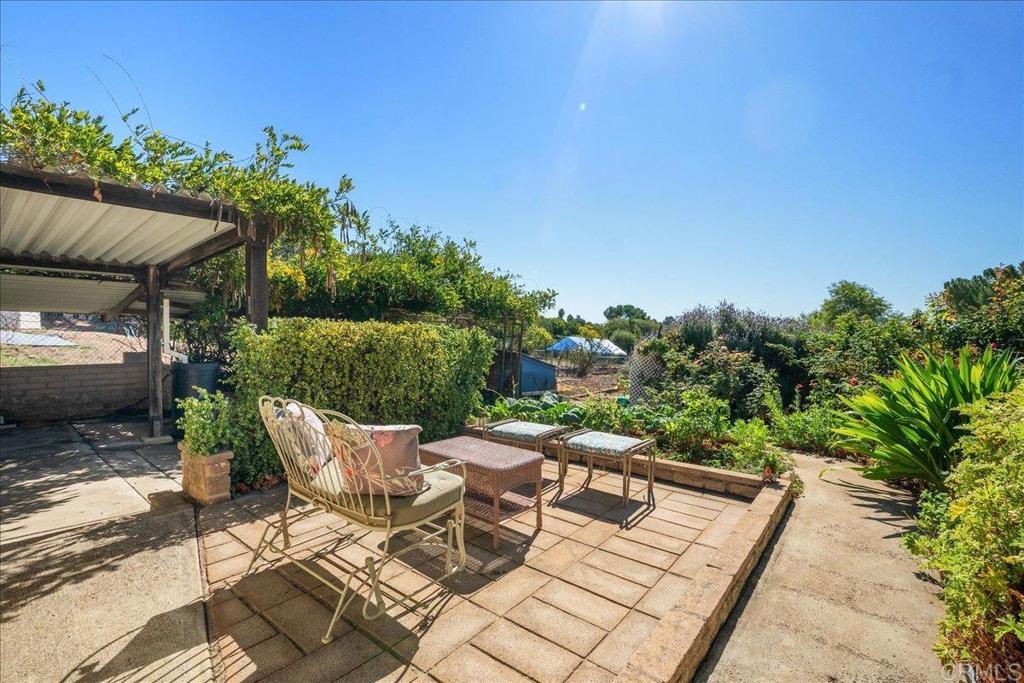 485 Wax Flower Lane Fallbrook, CA 92028 - Photo 25 of 31 a view of a patio with table and chairs potted plants with sky view