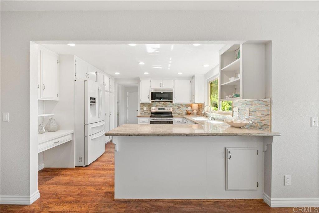 485 Wax Flower Lane Fallbrook, CA 92028 - Photo 4 of 31 a kitchen with stainless steel appliances granite countertop a stove a sink and a refrigerator