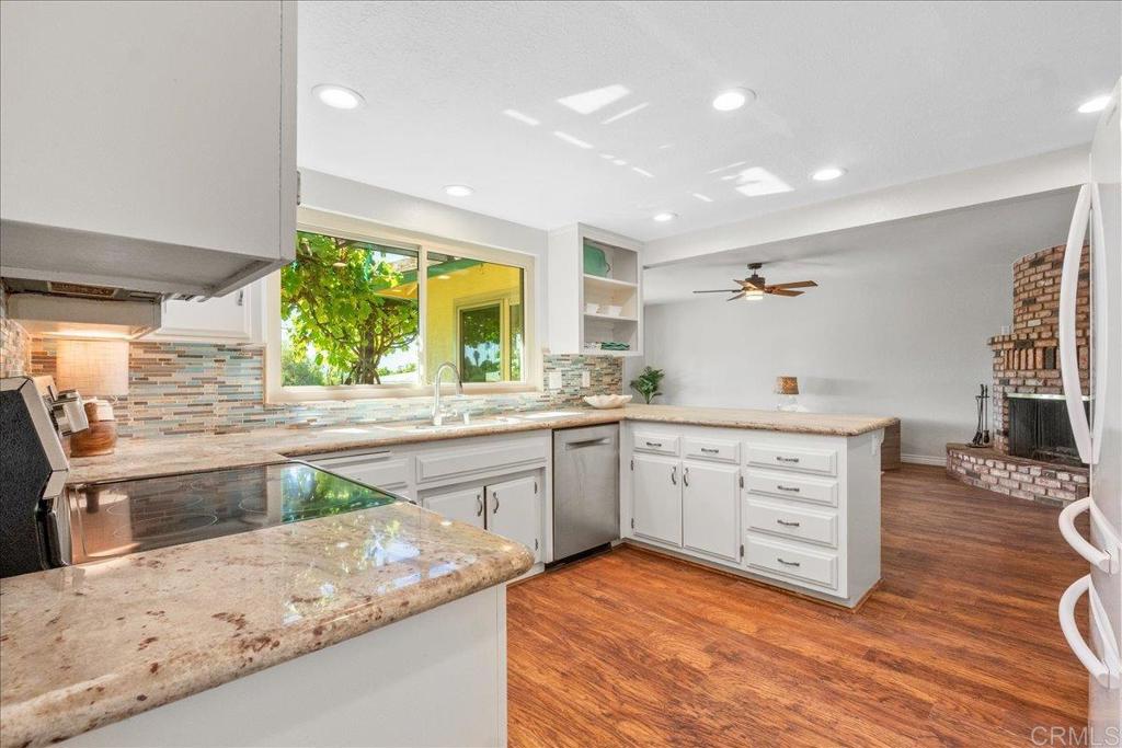 485 Wax Flower Lane Fallbrook, CA 92028 - Photo 5 of 31 a kitchen with sink cabinets and wooden floor