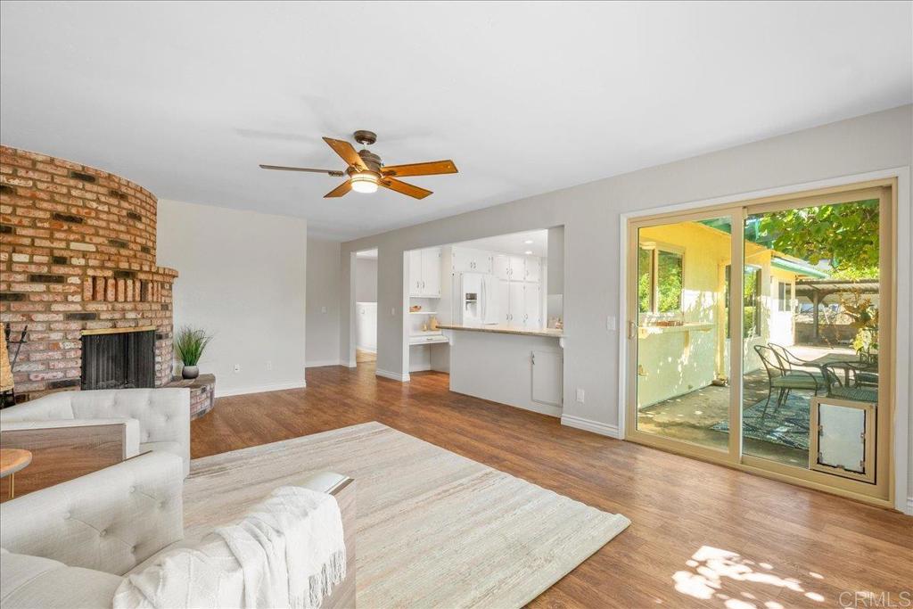 485 Wax Flower Lane Fallbrook, CA 92028 - Photo 6 of 31 a living room with fireplace furniture and a floor to ceiling window