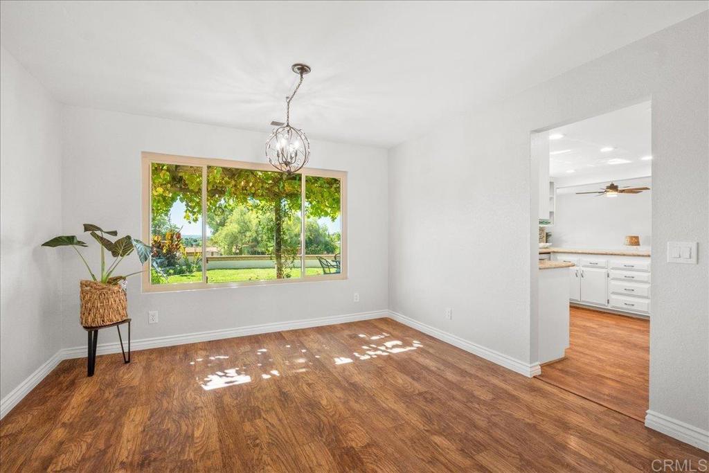 485 Wax Flower Lane Fallbrook, CA 92028 - Photo 8 of 31 a view of empty room with wooden floor and fan
