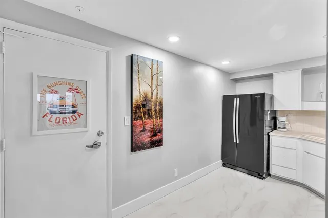 a kitchen with a sink and refrigerator
