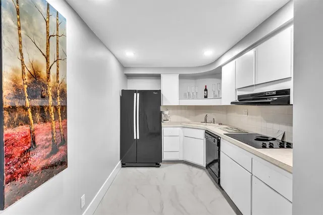 a kitchen with stainless steel appliances a refrigerator and a stove top oven