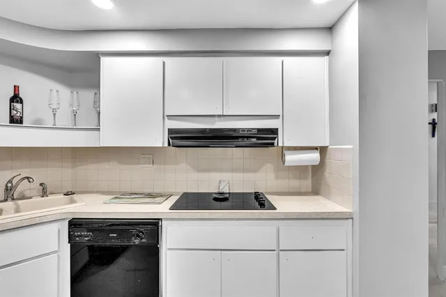 a kitchen with a sink dishwasher and cabinets