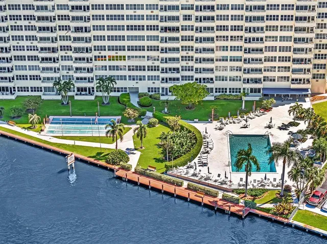 a view of swimming pool with outdoor seating and plants