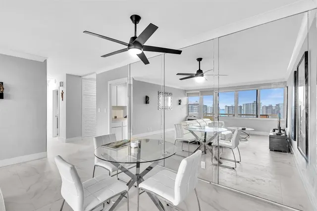 a view of a dining room and livingroom with furniture wooden floor a chandelier