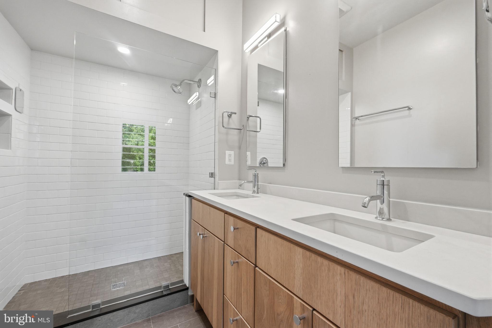 706 12th Street Northeast Washington, DC 20002 - Photo 23 of 49 a bathroom with a sink double vanity and a mirror