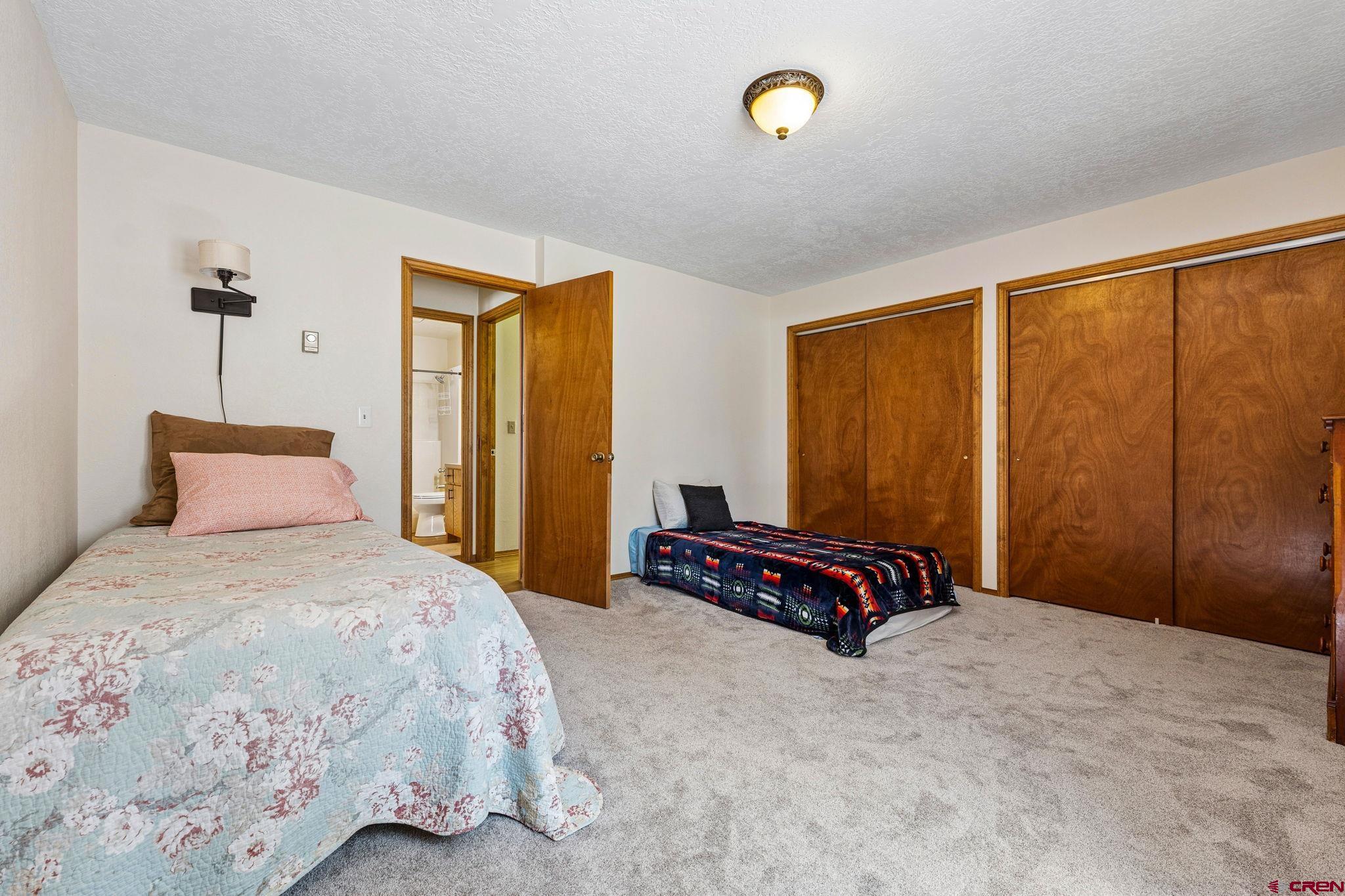 1024 Deer Ridge Drive Bayfield, CO 81122 - Photo 25 of 45 a bedroom with a large bed and a window