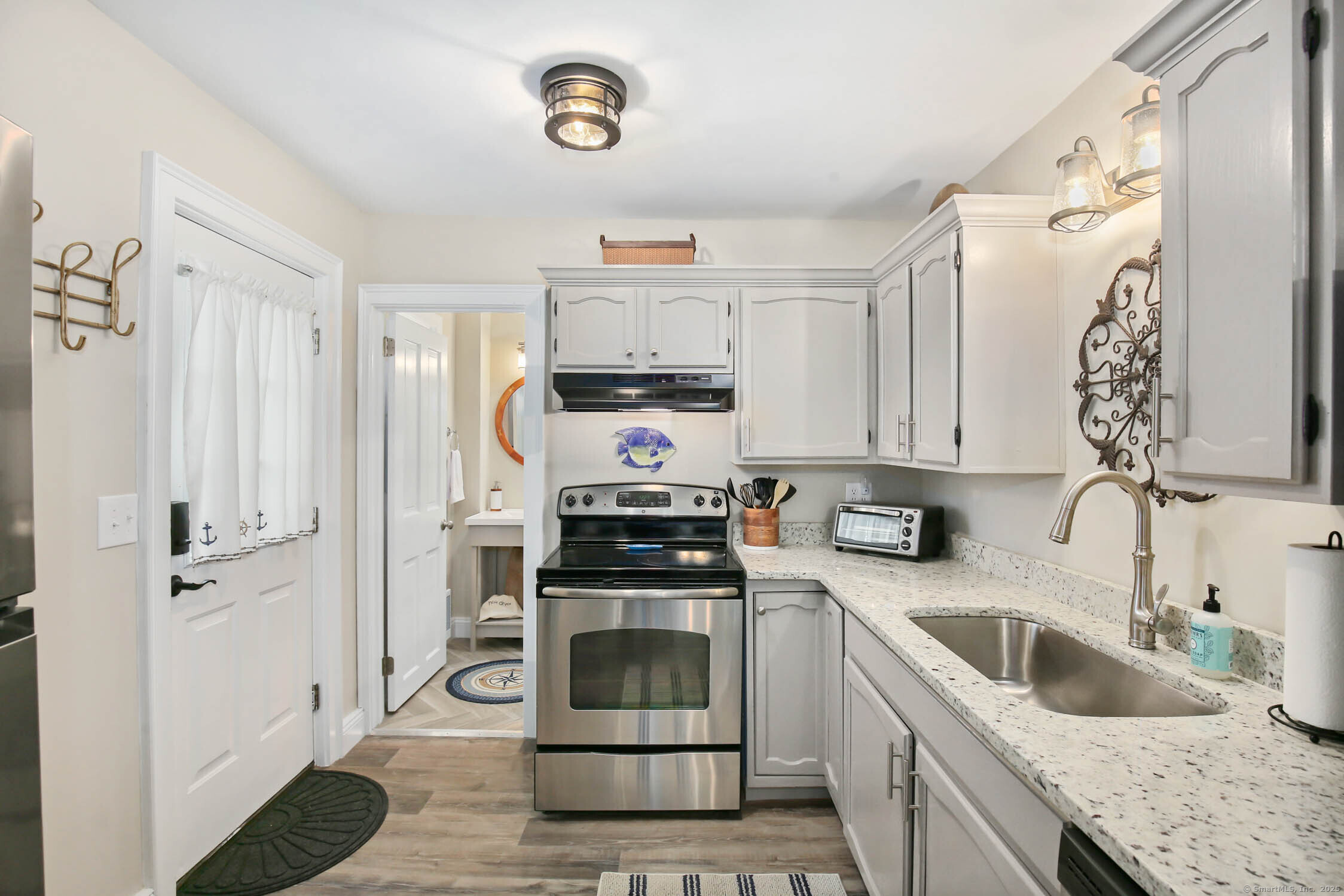 48 Wrights Crossing Road Pomfret, CT 06259 - Photo 14 of 34 a kitchen with white cabinets and white appliances