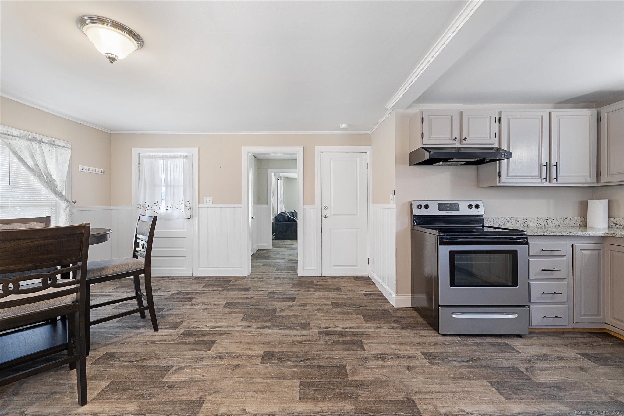48 Wrights Crossing Road Pomfret, CT 06259 - Photo 21 of 34 a kitchen with stainless steel appliances a stove a sink cabinets and a window