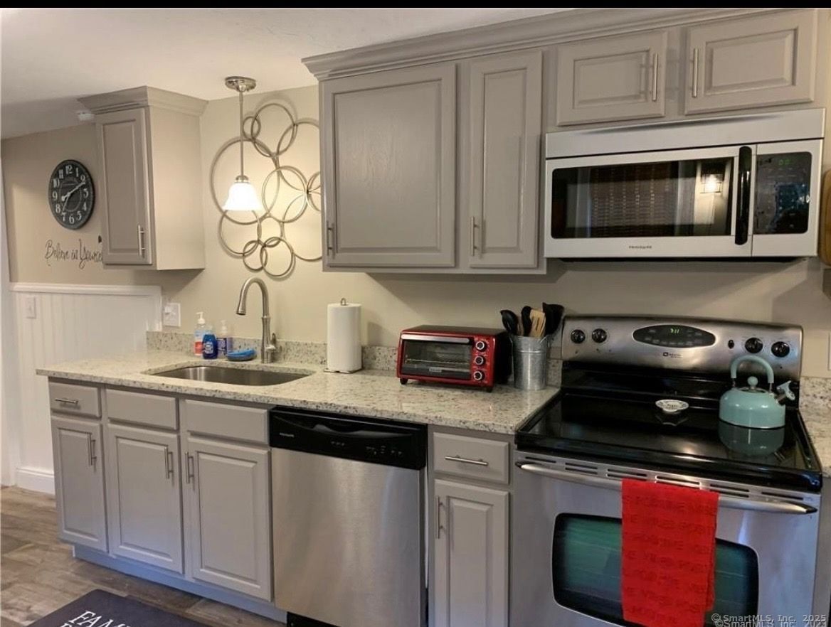 48 Wrights Crossing Road Pomfret, CT 06259 - Photo 28 of 34 a kitchen with stainless steel appliances granite countertop a sink and a stove