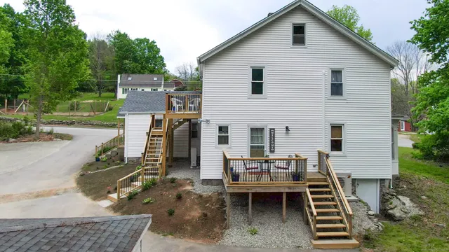 a backyard of a house with barbeque oven and outdoor seating
