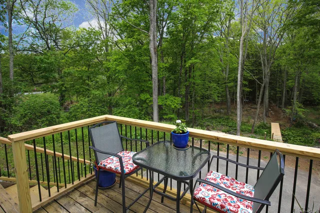 a view of a deck with a chair and wooden floor