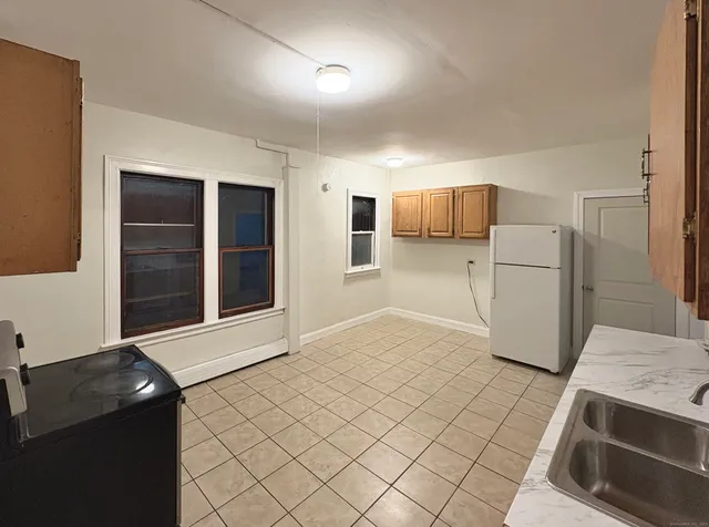 a kitchen with a sink and a refrigerator