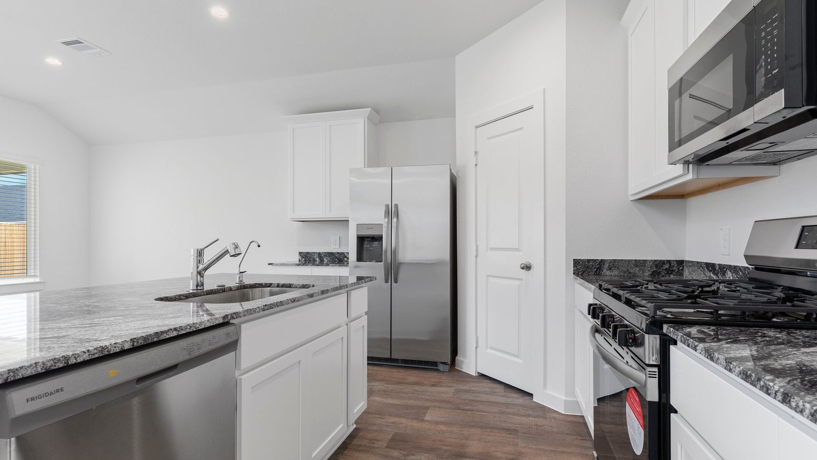 4520 Highland Oaks Court Rosenberg, TX 77469 - Photo 13 of 48 a kitchen with stainless steel appliances granite countertop a sink stove and refrigerator