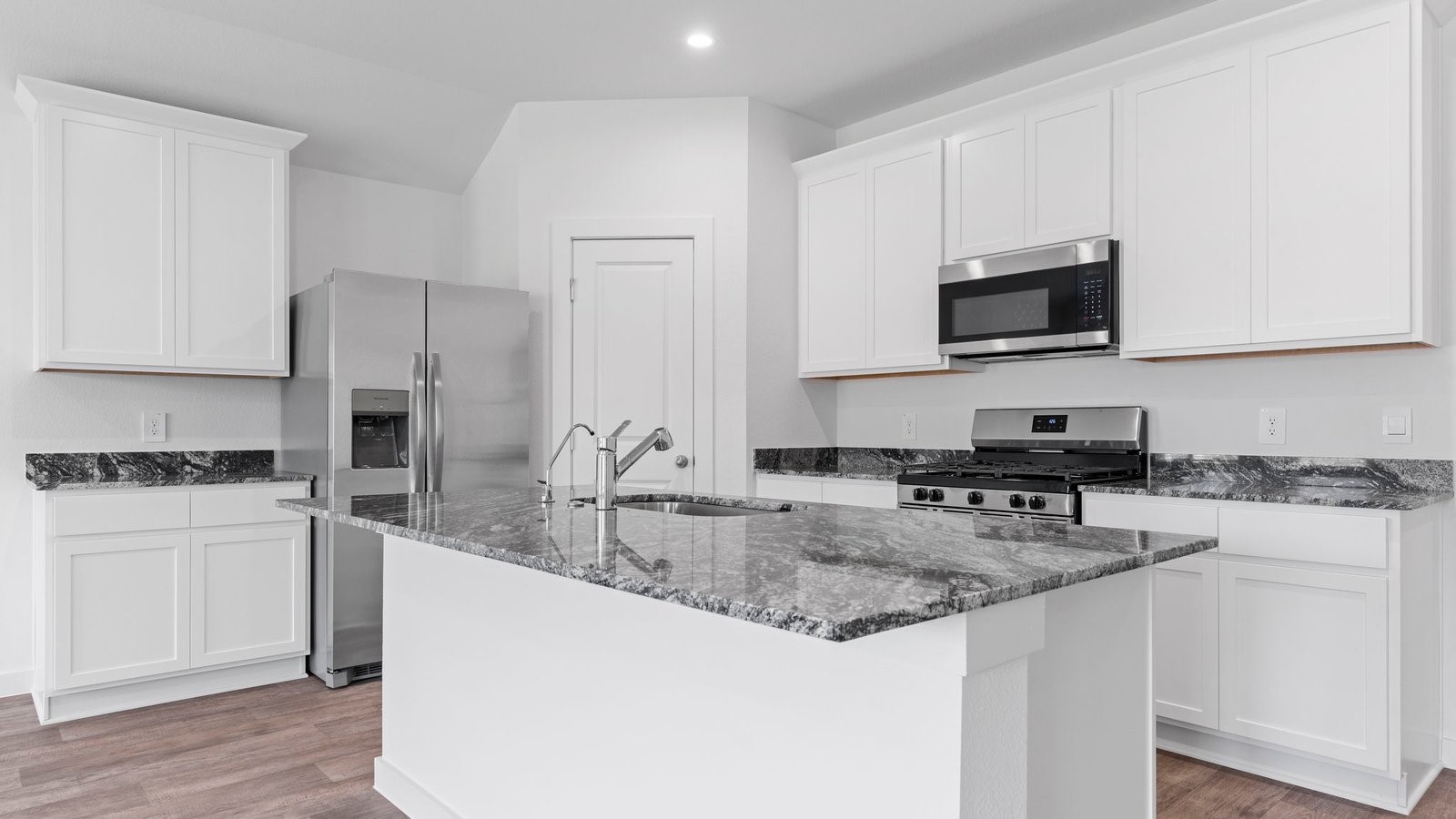4520 Highland Oaks Court Rosenberg, TX 77469 - Photo 14 of 48 a kitchen with granite countertop a stove sink and microwave