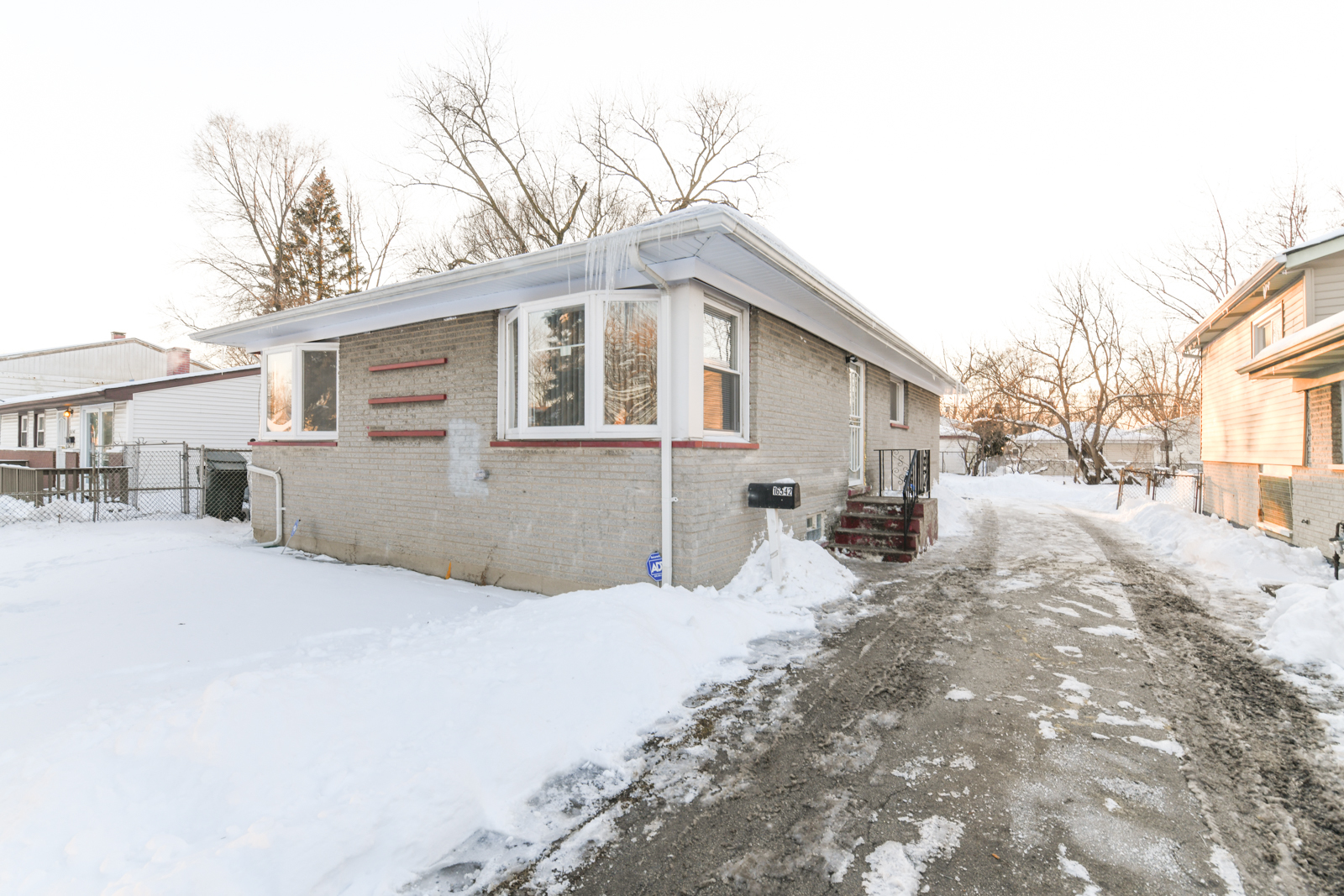 16542 Paulina Street Markham, IL 60428 - Photo 1 of 29 a view of a house with a yard covered in snow