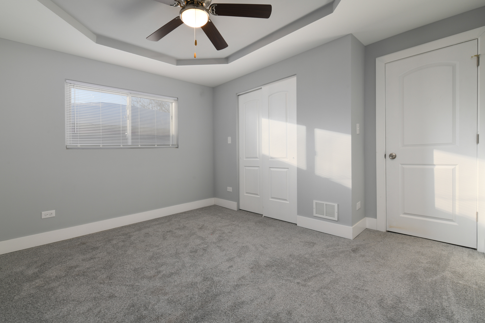 16542 Paulina Street Markham, IL 60428 - Photo 16 of 29 an empty room with chandelier fan and windows