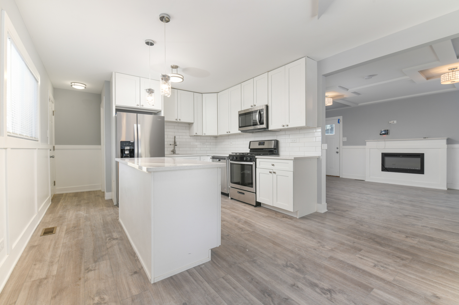 16542 Paulina Street Markham, IL 60428 - Photo 2 of 29 a kitchen with white cabinets and stainless steel appliances