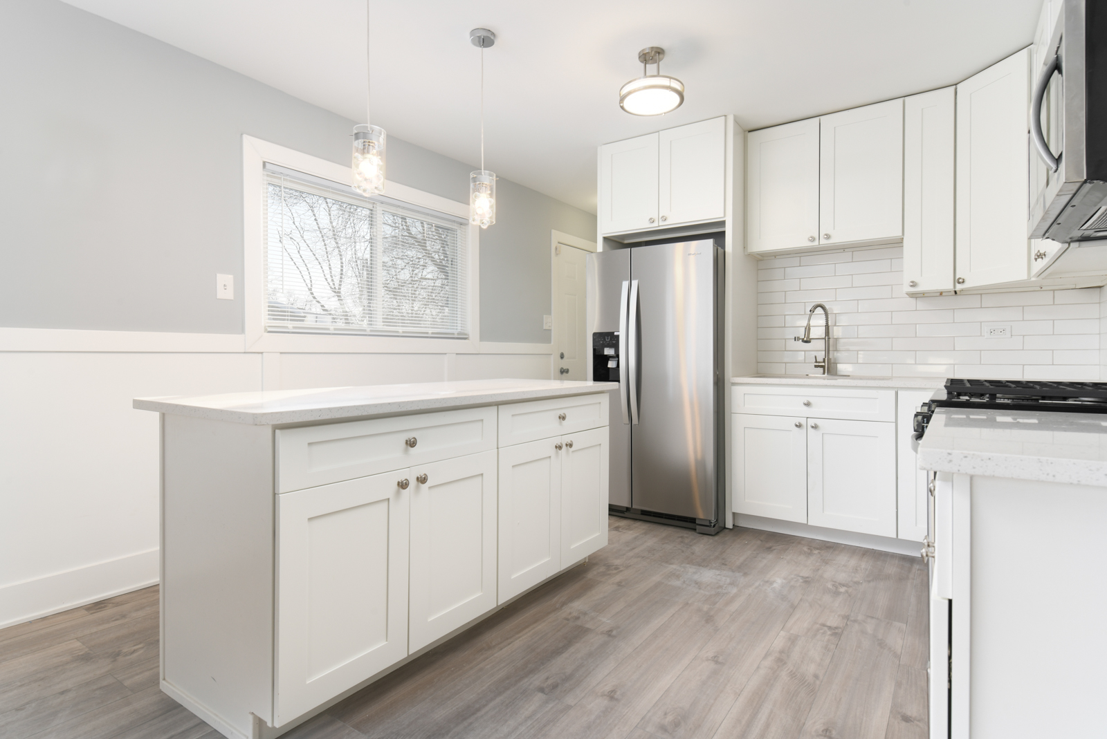 16542 Paulina Street Markham, IL 60428 - Photo 3 of 29 a kitchen with white cabinets and white appliances