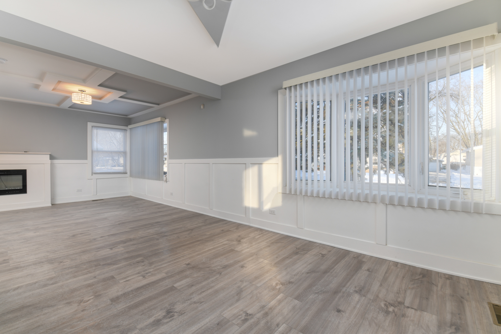 16542 Paulina Street Markham, IL 60428 - Photo 7 of 29 a view of an empty room with wooden floor and a window