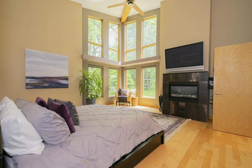 15 Turning Mill Road Lexington, MA 02420 - Photo 24 of 42 a bedroom with a bed and a flat screen tv