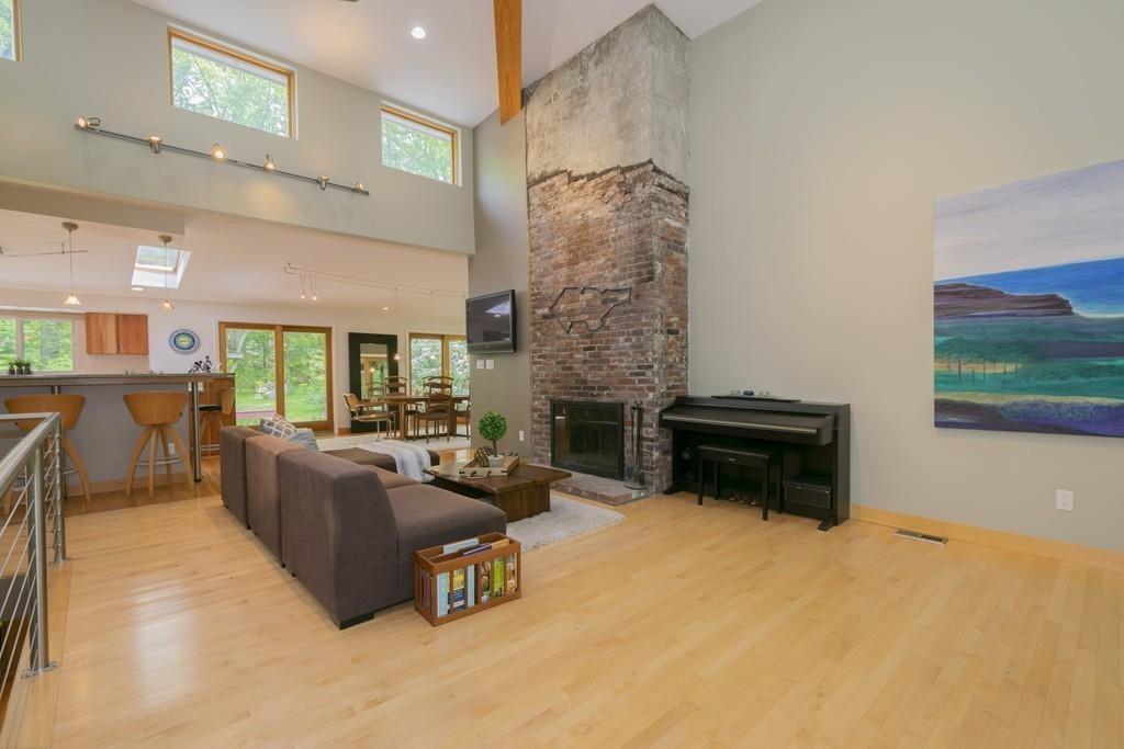 15 Turning Mill Road Lexington, MA 02420 - Photo 10 of 42 a living room with furniture a fireplace and a flat screen tv